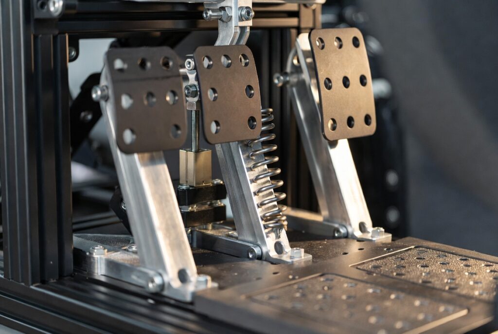 Premium load cell pedals mounted on an aluminum rig highlighting the importance of braking control over torque